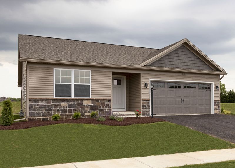  Exterior front view of the Elmcrest A ranch floorplan by S&A Homes - single story  home with vinyl siding, stone kneewall, and two car garage with gable above 